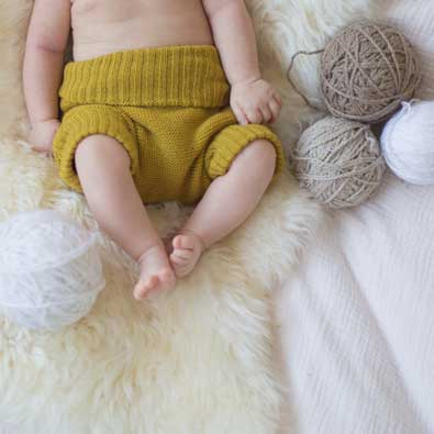 baby in a wool nappy cover